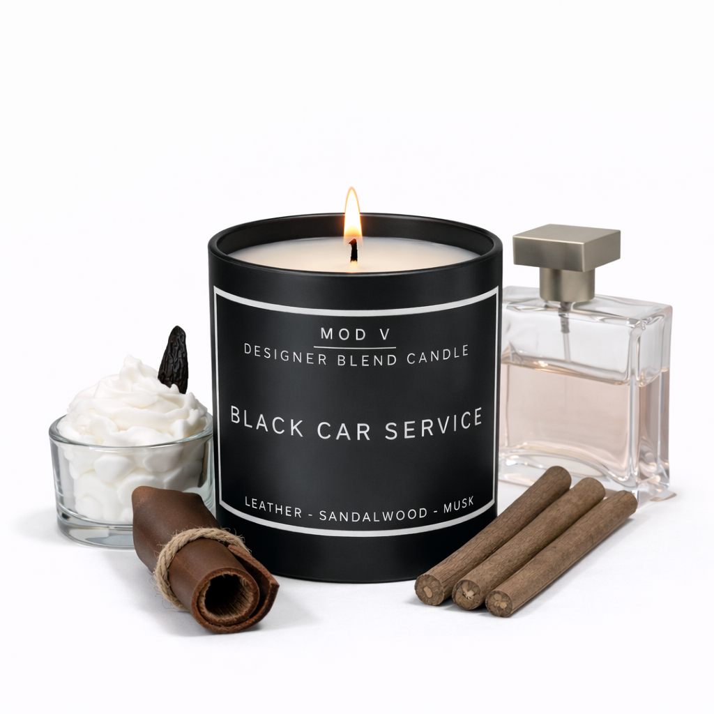 Candle labeled 'Black Car Service' with a glass of whipped cream, cinnamon stick, and perfume bottle on a white background