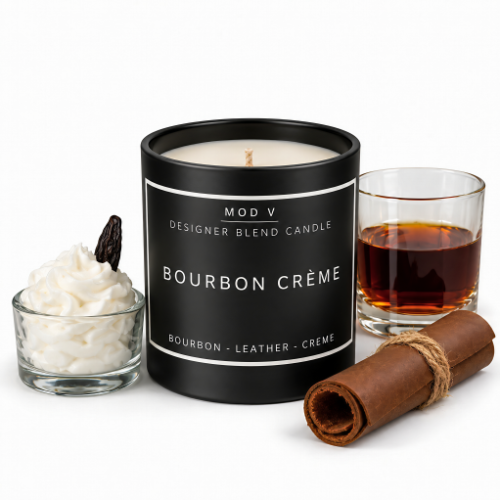 A black candle jar labeled 'MOD V DESIGNER BLEND CANDLE BOURBON CRÈME' on a white background, styled with whipped cream, a cinnamon stick, and a glass of amber liquid.