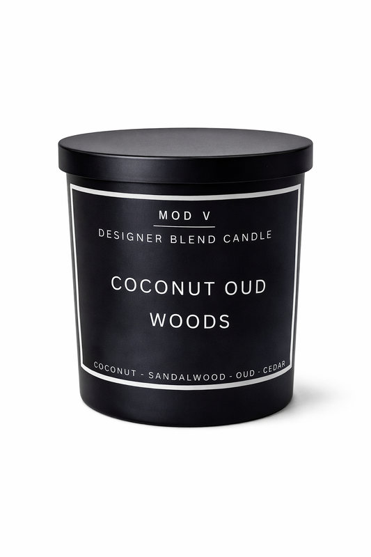 Black candle with 'Coconut Oud Woods' label on a white background