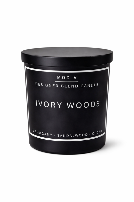 Black candle with 'IVORY WOODS' label on a white background