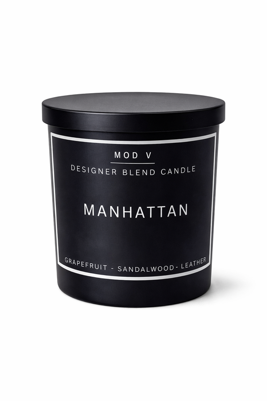 Black candle with 'Manhattan' label on a white background