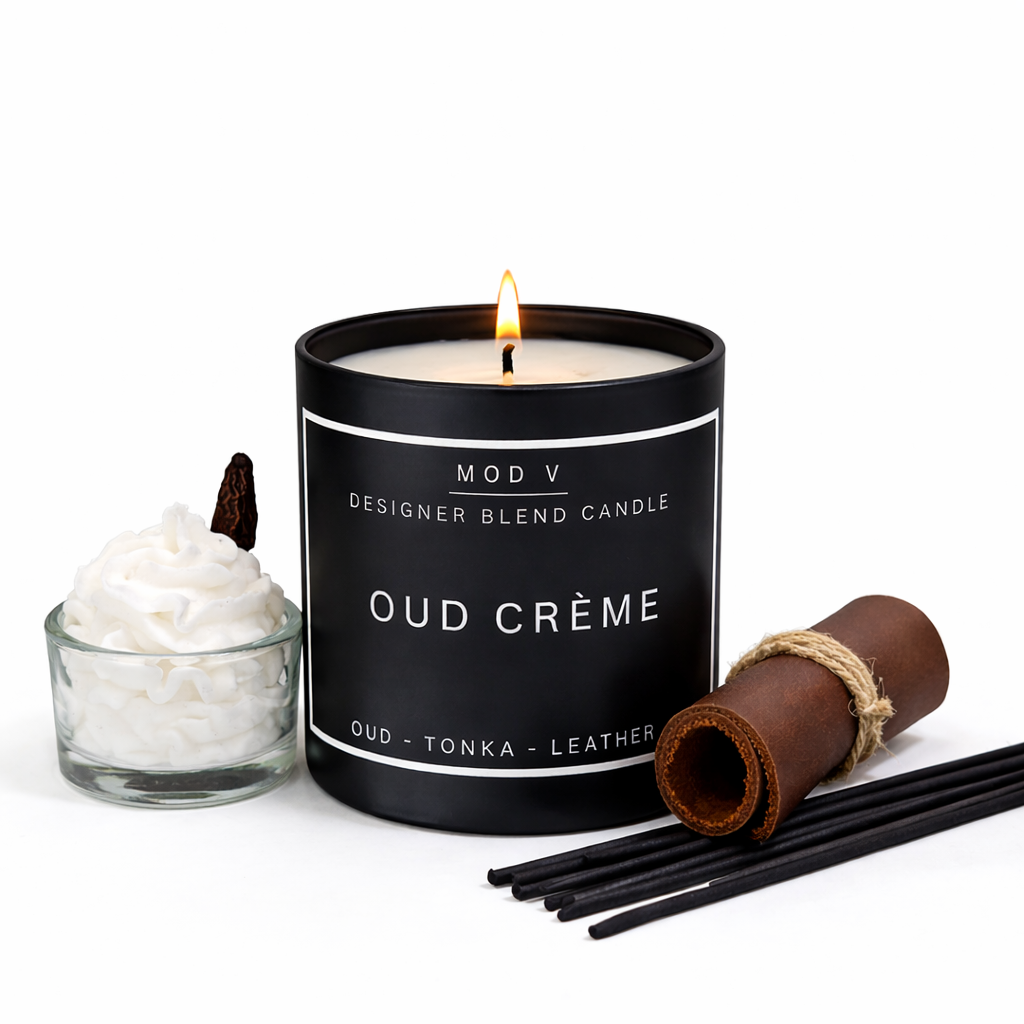 Black candle labeled 'Oud Crème' with decorative items on a white background