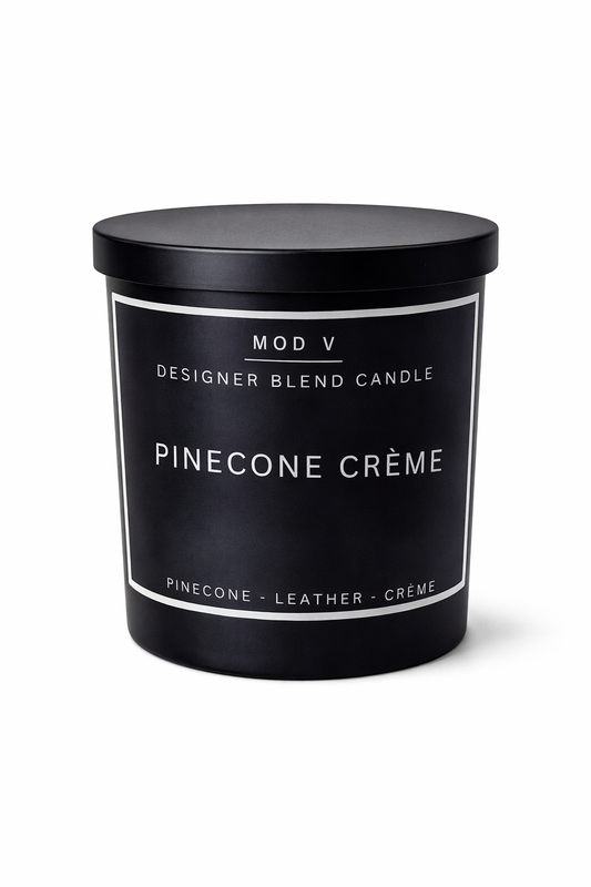 Black candle with 'Pinecone Crème' label on a white background