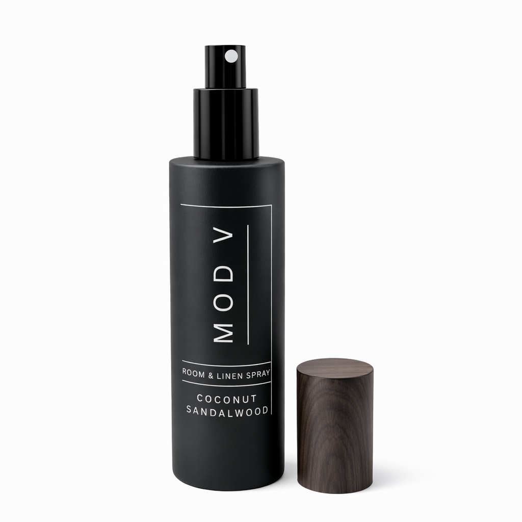 Black room & linen spray bottle with wooden diffuser on a white background