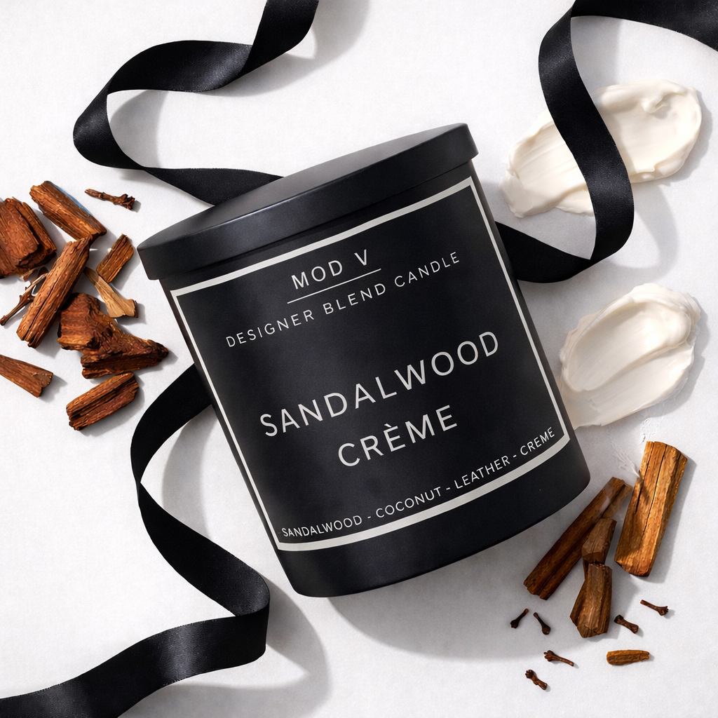 Black candle container labeled 'Sandalwood Crème' with sandalwood pieces and a black ribbon on a white background