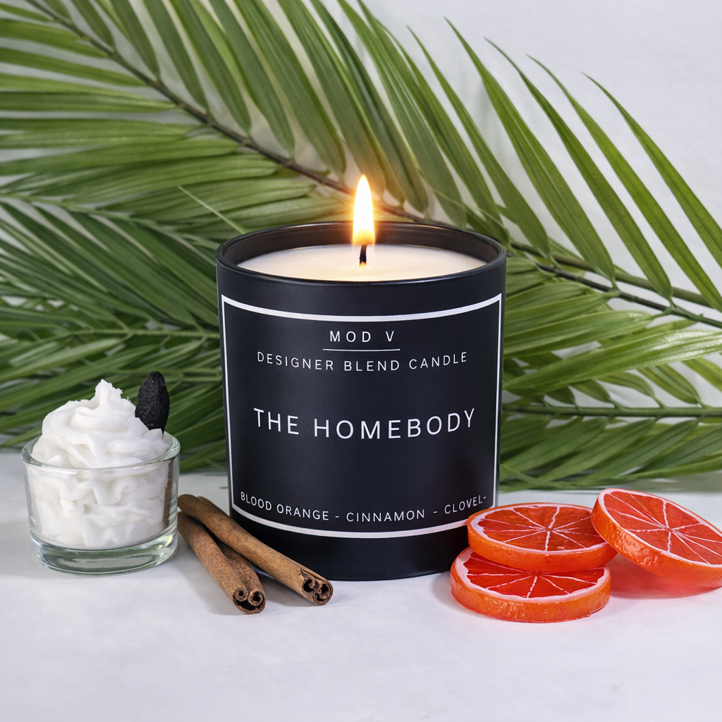 Candle labeled 'The Homebody' with decorative elements on a white surface