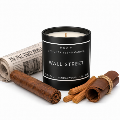 A black candle jar labeled 'WALL STREET' by MOD V, styled with a rolled newspaper, a cigar, and cinnamon sticks on a white background.