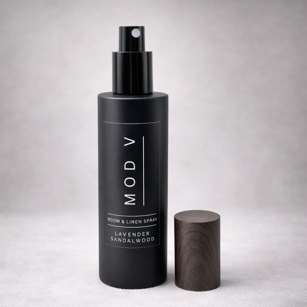 Black room and linen spray bottle with wooden cap on a light gray background